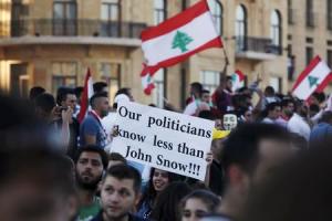 People carry Lebanese national flags and banners as &hellip;