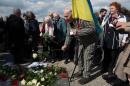 A former prisoner, Petro Mischtschuk from Ukraine, lays flowers during a commemorative event on the 70th anniversary of the liberation of Buchenwald concentration camp in Weimar, Germany, on April 11, 2015
