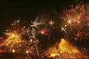 Fireworks explode above a floating mosque during New Year's Eve celebrations at Losari beach in Makassar