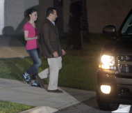 Casey Anthony, left, walks to a SUV with her lawyer Jose Baez after she was released from the Orange County Jail in Orlando, Fla., early Sunday, July 17, 2011. Anthony was acquitted last week of murder in the death of her daughter, Caylee. (AP Photo/John Raoux)