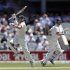 Australia's Warner runs past his captain Clarke as he celebrates scoring a century during their second cricket test match against South Africa at the Adelaide cricket ground