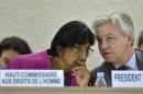 UN High Commissioner for Human Rights South African Navi Pillay, left, speaks with Polish Remigiusz Henczel, right, President of the Human Rights Council, during the urgent debate on the situation in Syria at the 23rd session of the Human Rights Council, at the European headquarters of the United Nations in Geneva, Switzerland, Wednesday, May 29, 2013. Syria's civil war is spilling out of control and represents a massive failure to protect citizens against war crimes and crimes against humanity that are now a routine occurrence according to the U.N.'s top human rights official Pillay. (AP Photo/Keystone, Martial Trezzini)