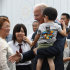U.S. Vice President Joe Biden, center, with a child survivors of the March 11 earthquake and tsunami, at a temporary housing complex for tsunami victims in Natori, one of the hardest quake stricken city, northeastern Japan, Tuesday, Aug. 23, 2011. (AP Photo/Shizuo Kambayashi)