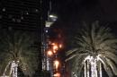A fire runs up some 20 stories of a building in Dubai, United Arab Emirates, Thursday, Dec. 31, 2015. The fire broke out Thursday in a residential building near Dubai's massive New Year's Eve fireworks display. It was not immediately clear what caused the fire near the Burj Khalifa, the world's tallest skyscraper at 828 meters (905 yards). (AP Photo/Jon Gambrell)
