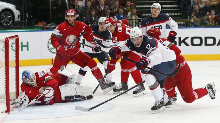 USA forward Kevin Hayes, right, attempts to score during the Group B preliminary round match between Belarus and USA at the Ice Hockey World Championship in Minsk, Belarus, Friday, May 9, 2014