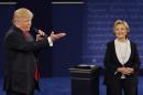 Republican presidential nominee Donald Trump speaks with Democratic presidential nominee Hillary Clinton during the second presidential debate at Washington University in St. Louis, Sunday, Oct. 9, 2016. (AP Photo/John Locher)