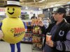 A customer smiles after receiving a free Mega Millions Lottery ticket from the Hoosier Lottery's Mega Millions mascot at a store in Zionsville, Ind., Friday, March 30, 2012. The Mega Millions Lottery jackpot has reached more than $600 million. (AP Photo/Michael Conroy)