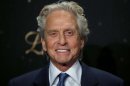 US actor Michael Douglas smiles as he arrives for the Germany premiere of the movie 'Behind The Candelabra' in Berlin, Germany, Monday, Sept. 2, 2013. (AP Photo/Michael Sohn)