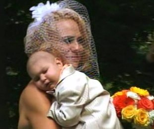 Bride Christine Swidorsky carries her ill son down the aisle at her wedding.