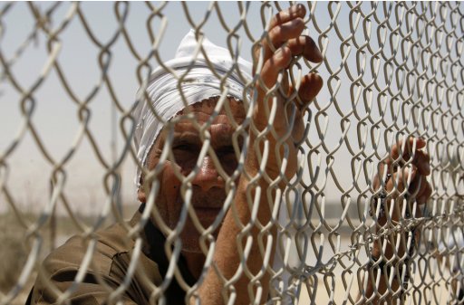 A Palestinian man takes part in a rally at Rafah border crossing in the Gaza Strip