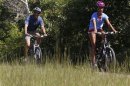 U.S. President Barack Obama bike rides with his oldest daughter, Malia, while on vacation in Martha's Vineyard