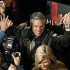 Republican presidential candidate former Utah Gov. Jon Huntsman follows his wife, Mary Kaye, as they enter a campaign rally in Exeter, N.H., Monday, Jan. 9, 2012. (AP Photo/Elise Amendola)