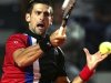 Djokovic of Serbia returns the ball to Tomic of Australia during their match at the Rome Masters tennis tournament