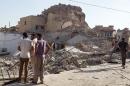 People inspect the destroyed old Mosque of The Prophet Jirjis in central Mosul, Iraq, Sunday, July 27, 2014. The revered Muslim shrine was destroyed on Sunday by militants who overran the city in June and imposed their harsh interpretation of Islamic law. (AP Photo)