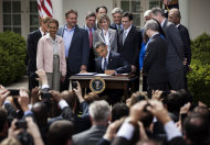 US President Barack Obama signs the 