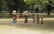 Villagers wade through flood waters at Baharal village, in Malda district, in the eastern Indian state of West Bengal, Saturday, Aug. 20, 2011. Flood situation in West Bengal continued to be grim as the death toll shot to 36 Thursday, according to a news agency. India receives much of its rainfall during the monsoon season which lasts from July to September. (AP Photo)