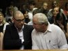 Oscar Pistorius' brother Carl and father Henke await the start of court proceedings in the Pretoria Magistrates court