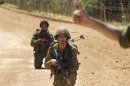 Israeli soldiers patrol along Israel's border with Lebanon near Avivim