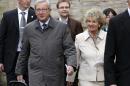 Luxembourg's Prime Minister Jean-Claude Juncker, front left, and his wife Christiane walk to a polling station to casts his vote, in Capellen, Luxembourg, Sunday Oct. 20, 2013. Polls opened in Luxembourg for legislative elections on Sunday, with Prime Minister Juncker hoping to win another term in office after an intelligence scandal brought down his government earlier this year. Juncker is the European Union's longest-serving premier after 18 years in office. (AP Photo/Yves Logghe)
