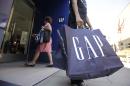 FILE - In this Aug. 9, 2009, file photo, a shopper leaves a Gap store in Palo Alto, Calif. The nation's largest clothing chain, which operates, Gap, Old Navy, Banana Republic and Athleta, said it would raise the wages to $10 by 2015. (AP Photo/Paul Sakuma, File)