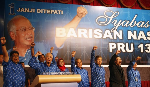 Malaysia's Prime Minister Najib Razak (2nd L) and his other party leaders shout slogans after winning the elections at his party headquarters in Kuala Lumpur early May 6, 2013. Malaysia's governing coalition won a tight national election on Sunday to extend its 56-year rule, fending off an opposition alliance that pledged to clean up politics and end race-based policies in Southeast Asia's third-largest economy. REUTERS/Bazuki Muhammad (MALAYSIA - Tags: POLITICS ELECTIONS)