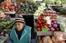 A woman sits at her vegetable stand at a market in downtown Quito, Ecuador, Thursday, June 27, 2013. Unlike with China, Russia or Cuba, countries where the U.S. has relatively few tools to force Edward Snowden's handover, the Obama administration could swiftly hit Ecuador in the pocketbook by denying reduced tariffs on cut flowers, artichokes and broccoli if it grants Snowden's request for asylum. Those represent hundreds of millions of dollars in annual exports for this country where nearly half of foreign trade depends on the U.S. (AP Photo/Dolores Ochoa)