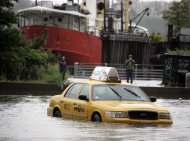 A New York City taxi is stranded in deep water on Manhattan’s West Side as Tropical Storm Irene passes through the city, Sunday, Aug. 28, 2011 in New York. Although downgraded from a hurricane to a tropical storm, Irene’s torrential rain couple with high winds and tides worked in concert to flood parts of the city. (AP Photo/Peter Morgan)