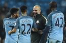 Manchester City's manager Pep Guardiola (C) congratulates Raheem Sterling (L), Gael Clichy (2ndL) and Yaya Toure on December 18, 2016