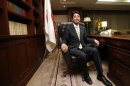 Newly elected Japan's main opposition Liberal Democratic Party President Shinzo Abe sits in the presidential seat at the party headquarters in Tokyo