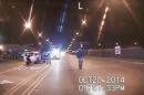 In this Oct. 20, 2014 frame from dash-cam video provided by the Chicago Police Department, Laquan McDonald, right, walks down the street moments before being shot by officer Jason Van Dyke in Chicago. Van Dyke, who shot McDonald 16 times, was charged with first-degree murder Tuesday, Nov. 24, 2015. (Chicago Police Department via AP)