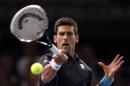 Djokovic of Serbia hits a returns to Herbert of France during the Paris Masters in Paris