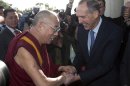 FILE - In this June 14, 2011 file photo, the Dalai Lama, left, is greeted by the Australian Greens leader Sen. Bob Brown at Parliament House in Canberra, Australia. Brown, the leader of the third force in Australian politics, has announced his resignation Friday, April 13, 2012. (AP Photo/Andrew Taylor, File)