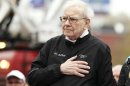 Berkshire Hathaway chairman Buffett sings the national anthem at a 5km race sponsored by Brooks Sports Inc. in Omaha