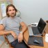 In this Sept. 2, 2011 photo, Ryan McGrath, 26, poses in his home in Michigan City, Ind. McGrath has been working part time designing web sites for small businesses but wants steadier full-time work. (AP Photo/Joe Raymond)