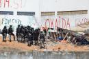 Members of the special police battalion enter the Alcacuz Penitentiary Center to regain control of the penitentiary in Rio Grande do Norte, Brazil, on January 18, 2017