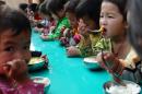 Children eat a free lunch at a communal kindergarten in Meo Vac district, in the northern mountainous province of Ha Giang, Vietnam