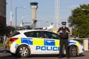A policeman stands guard outside London Luton airport in 2014