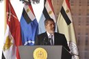 Egypt's President Mohamed Mursi speaks before watching a display of military maneuvers in the eastern Sinai