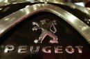 The Logo of French carmaker Peugeot is seen on a car in Paris