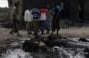 Resident look at their animals burnt during an attack in Kilelengwani village in Tana River Delta in Kenya's coastal region