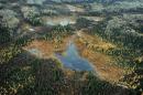 Aerial view of a lake and forests in Alberta Province, Canada on October 23, 2009
