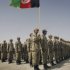 An Afghan police officer holds a national flag during a graduation ceremony in Herat, Afghanistan Wednesday, Aug 24, 2011. Over 200 Afghan police men graduated after getting 8 weeks of training by NATO and Afghan trainers in Herat. (AP Photo/Hoshan Hashimi)
