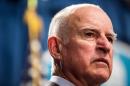 California Governor Brown looks on during a news conference at the State Capitol in Sacramento
