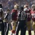 San Francisco 49ers and Baltimore Ravens players gather on the field during a power outage in the NFL Super Bowl XLVII football game in New Orleans