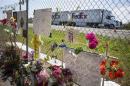 A FedEx truck drives past a makeshift memorial beside Interstate 5 in Orland, California