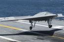 An X-47B Unmanned Combat Air System lands aboard the USS George H.W. Bush while afloat in the Atlantic Ocean off the coast from Norfolk, Virginia, in this July 10, 2013