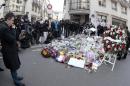 Flowers placed near the offices of French satirical weekly Charlie Hebdo in Paris on January 20, 2015, to pay tribute to the people killed during the Islamist attack
