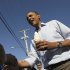 President Barack Obama holds a soft serve ice cream cone and shakes hands during his visit to DeWitt Dairy Treats, Tuesday, Aug. 16, 2011, in DeWitt, Iowa, during his three-day economic bus tour.  (AP Photo/Carolyn Kaster)