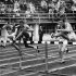 File- This July 26, 1952 file photo shows Milt Campbell, center, of Plainfield, N.J. getting set to clear the final hurdle to make him the winner in the fifth heat of the 110-meter hurdles event in the Olympic decathlon at Helsinki, Finland. Campbell, who became the first black to win the Olympic decathlon in 1956 and went on to play professional football and become a motivational speaker, died Friday Nov. 2, 2012 after a battle with prostate cancer. He was 78.   (AP Photo/File)