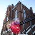 In this file photo of Sunday, Feb. 12, 2012, flowers and a card hang on a fence in front of New Hope Baptist Church in Newark, N.J. Whitney Houston's funeral will be held Saturday, Feb. 18 at the church where she sang in the choir as a girl. Houston, who ruled as pop music's queen until her majestic voice and regal image were ravaged by drug use, erratic behavior and a tumultuous marriage to singer Bobby Brown, died Saturday. She was 48.  (AP Photo/Mel Evans, file)